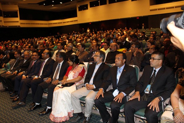 Picture12 - Toronto Bangla Town | Digital Bangla Weekly Magazine Large audience seated in a theater during a conference or formal event, many people in suits watching attentively.