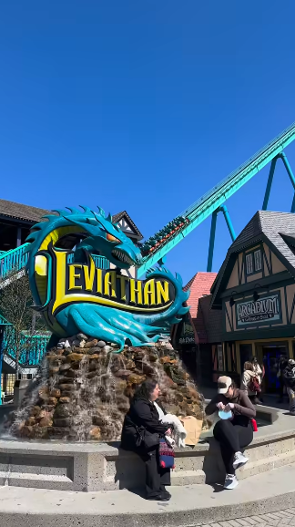 Picture2 - Toronto Bangla Town | Digital Bangla Weekly Magazine Entrance to the Leviathan roller coaster with a blue dragon sign and people nearby.