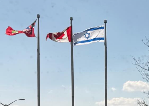 Picture7 - Toronto Bangla Town | Digital Bangla Weekly Magazine Three national flags—Turkey, Canada, and Israel—flying on flagpoles against a clear blue sky.