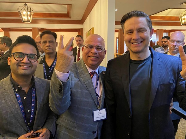 Picture5 - Toronto Bangla Town | Digital Bangla Weekly Magazine Three men in suits posing for a photo at a conference, two flashing peace signs.