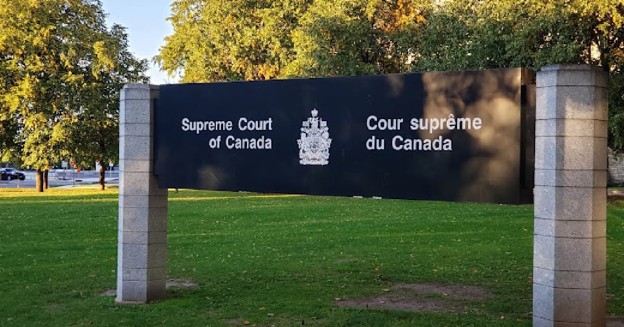 Picture5 - Toronto Bangla Town | Digital Bangla Weekly Magazine Sign for the Supreme Court of Canada in English and French, with a crest, mounted between two stone posts on a green lawn.