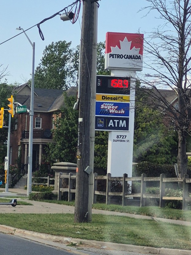 Picture9 - Toronto Bangla Town | Digital Bangla Weekly Magazine Petro-Canada gas station sign with price board, Diesel, Self-Serve, and ATM panels, located beside a residential street intersection.